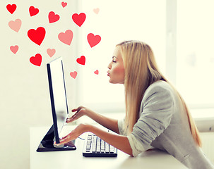 Image showing woman sending kisses with computer monitor