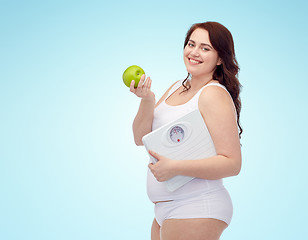 Image showing happy young plus size woman holding scales