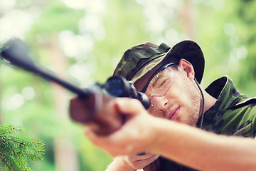 Image showing young soldier or hunter with gun in forest