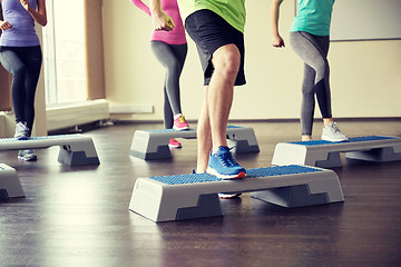 Image showing group of people flexing legs on step platforms