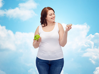 Image showing happy plus size woman choosing apple or donut