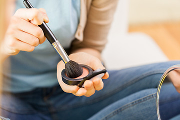 Image showing close up of woman with makeup brush and blush