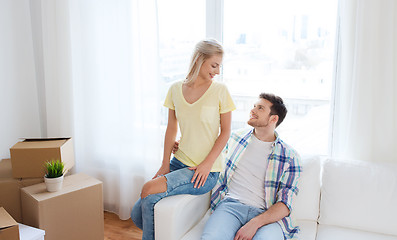 Image showing happy couple with big cardboard boxes at new home