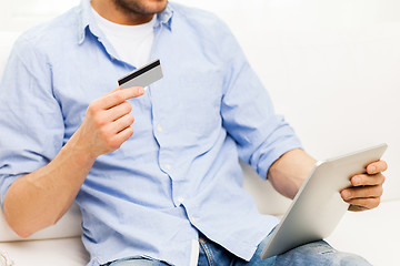 Image showing close up of man with tablet pc and credit card