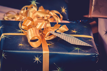 Image showing Christmas gifts with golden ribbon