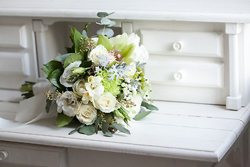 Image showing Wedding bouquet with white roses on wooden surface