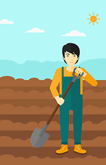 Image showing Farmer on the field with shovel.