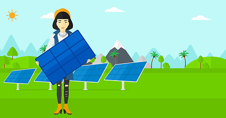 Image showing Woman holding solar panel.