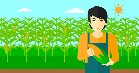 Image showing Farmer holding corn.
