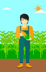 Image showing Farmer holding corn.