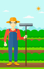 Image showing Farmer with rake.