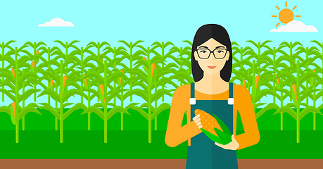 Image showing Farmer holding corn.