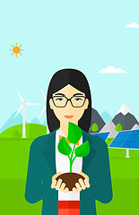 Image showing Woman holding plant.