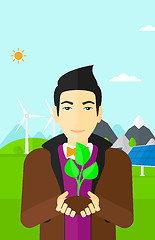 Image showing Man holding plant.