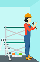 Image showing Constructor hammering nail.