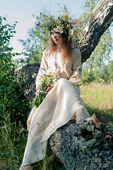 Image showing Woman in national dress and flower wreath on tree