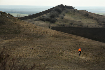 Image showing Man cyclist with backpack riding the bicycle