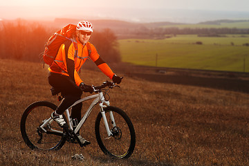 Image showing Man cyclist with backpack riding the bicycle