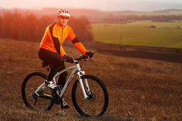 Image showing Man cyclist with backpack riding the bicycle