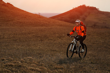 Image showing Man cyclist with backpack riding the bicycle