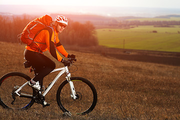 Image showing Man cyclist with backpack riding the bicycle