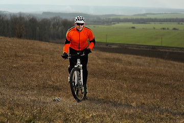 Image showing Man cyclist with backpack riding the bicycle