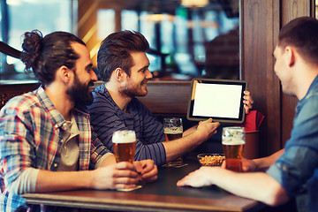 Image showing male friends with tablet pc drinking beer at bar