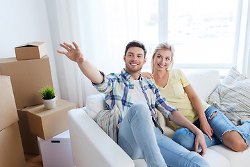 Image showing couple with boxes moving to new home and dreaming