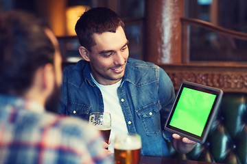 Image showing male friends with tablet pc drinking beer at bar