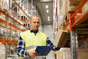 Image showing man with clipboard in safety vest at warehouse