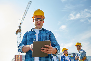 Image showing builder in hardhat with tablet pc at construction