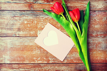 Image showing close up of tulips and greeting card with heart