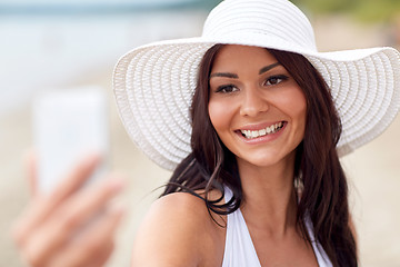 Image showing young woman taking selfie with smartphone