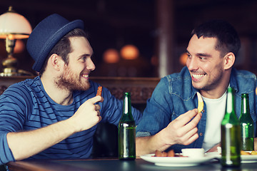 Image showing happy male friends drinking beer at bar or pub