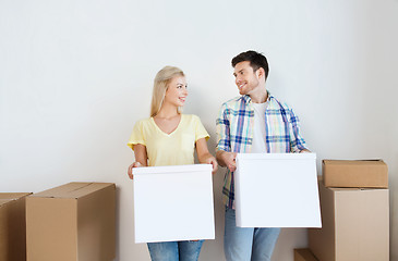 Image showing smiling couple with big boxes moving to new home