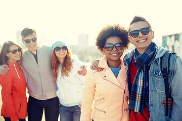 Image showing happy teenage friends in shades talking on street