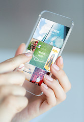 Image showing close up of woman with news pages on smartphone