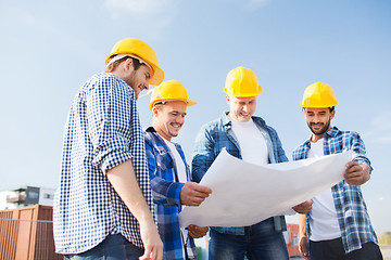 Image showing group of builders with tablet pc and blueprint