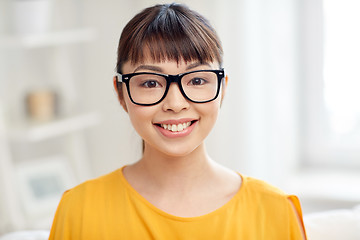 Image showing happy asian young woman in glasses at home