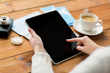 Image showing close up of traveler hands with tablet pc and map