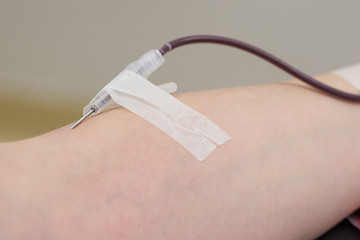 Image showing Donor in an armchair donates blood,, close-up