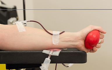 Image showing Donor in an armchair donates blood,, close-up