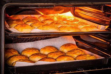 Image showing Hot oven with golden buns