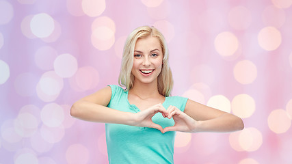 Image showing happy woman or teen girl showing heart shape sigh