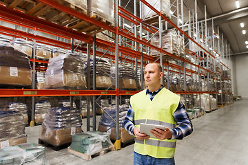 Image showing manual worker with tablet pc at warehouse