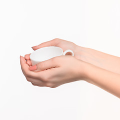 Image showing Woman hand with cup on white background