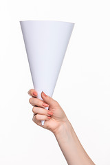 Image showing The white cone in the  female hands on white background