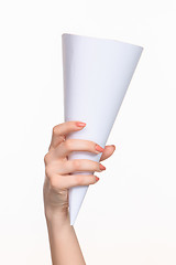 Image showing The white cone in the  female hands on white background