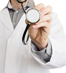 Image showing Close up of a Doctor\'s hand, holding a stethoscope 