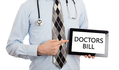 Image showing Doctor holding tablet - Doctors bill